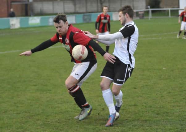 Bexhill United midfielder Sammy Bunn tussles for possession during last weekend's 1-1 draw at home to AFC Varndeanians. Pictures by Simon Newstead