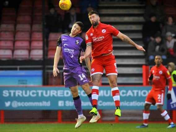 Crawley Town's Ollie Palmer and Port Vale's Adam Crookes go up for a header.
Picture by Steve Robards