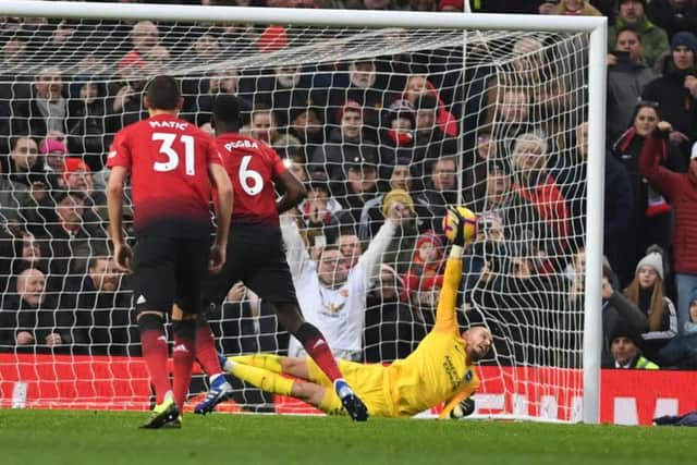 Paul Pogba strokes his penalty past David Button to give Manchester United the lead. Picture by PW Sporting Photography.