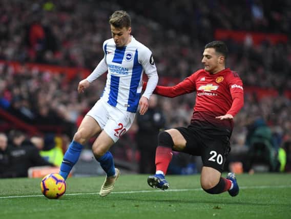 Solly March is challenged by Diogo Dalot. Picture by PW Sporting Photography