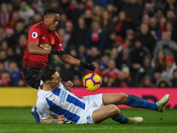 Lewis Dunk challenges Anthony Martial. Picture by PW Sporting Photography