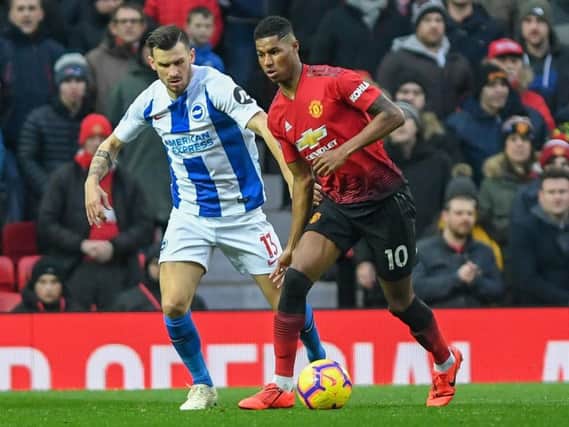 Pascal Gross closes down Marcus Rashford. Picture by PW Sporting Photography