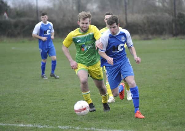 Westfield (yellow and green kit - Rob Higgins) v Roffey (blue and white kit) football action SUS-190120-112005002