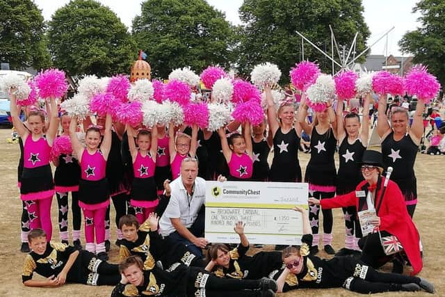 Worthing Community Chest with cheerleaders at Broadwater Carnival for a cheque presentation