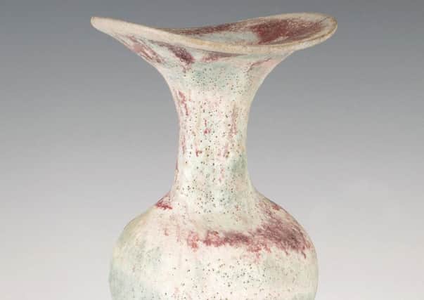 A Lucie Rie studio pottery stoneware bottle with flared asymmetrical rim and ovalled neck, covered in a pink and blue volcanic glaze. SUS-190121-113820001