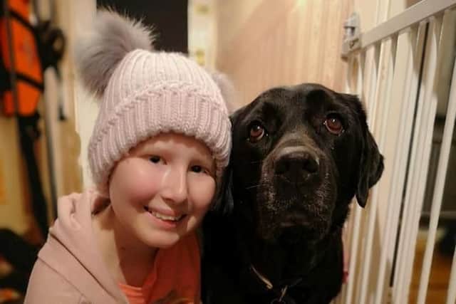 Keira Campbell, from Worthing, West Sussex, with her labrador Busby