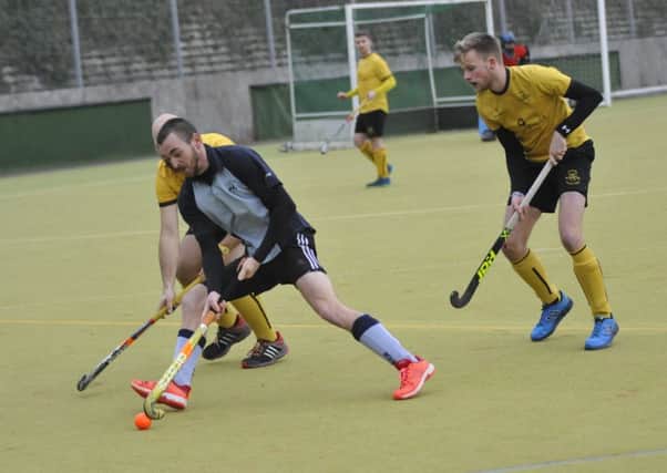 Alex Coombs takes on a pair of opposing defenders during South Saxons' 4-3 win at home to Marden Russets. Picture by Simon Newstead