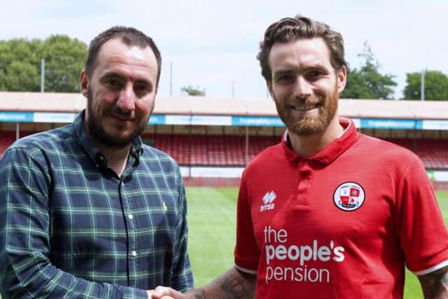 Crawley Town director of football Selim Gaygusuz with Romain Vincelot when he signed