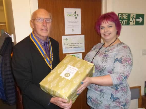 Samantha Gouldson, the deputy coordinator of the foodbank, with Littlehampton Rotary Club president Bruce Green in December