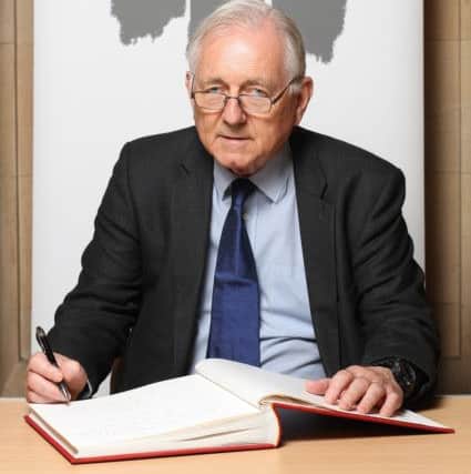 Sir Peter Bottomley signing Holocaust Book of Commitment