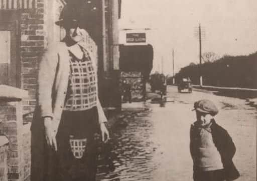 Flooding in Chichester in about 1927: residents Annie Shippam and her son Charlie outside their St Pancras home