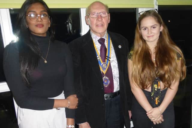 Dikaxiha Rajandran, left, and Catherine Topham with club president Bruce Green
