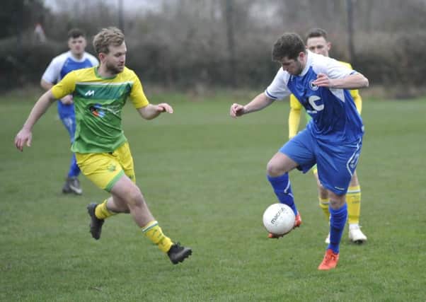 Westfield midfielder Rob Higgins closes down a Roffey opponent. Pictures by Simon Newstead