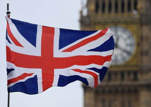 A Union flag flies near the Elizabeth Tower, commonly referred to as Big Ben, at the Houses of Parliament 700026947