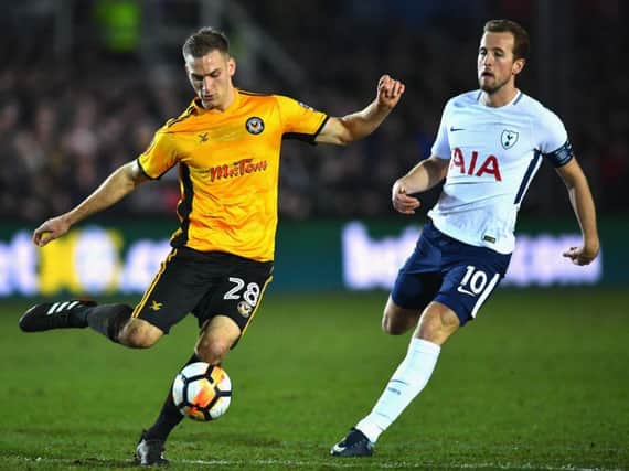 Mickey Demetriou is pressurised by England international Harry Kane during Newport's FA Cup clash against Tottenham Hotspur last season. Picture: Getty Images