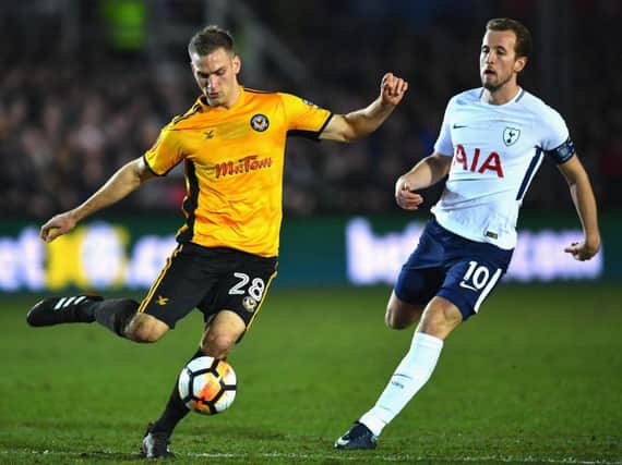 Mickey Demetriou is pressurised by England international Harry Kane during Newport's FA Cup clash against Tottenham Hotspur last season. Picture: Getty Images