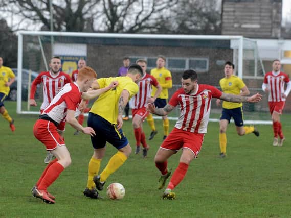 The yellow shirts of Sidlesham in action at home to Steyning / Picture by Kate Shemilt