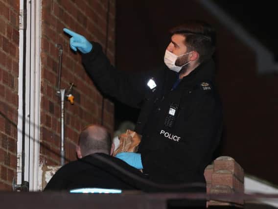 Police officers collecting evidence at the scene of the stabbings in Manning Road, Littlehampton
