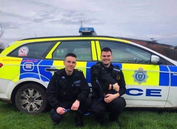 Police officers with Reggie the puppy. Photo: South Wales Police in Swansea/Twitter