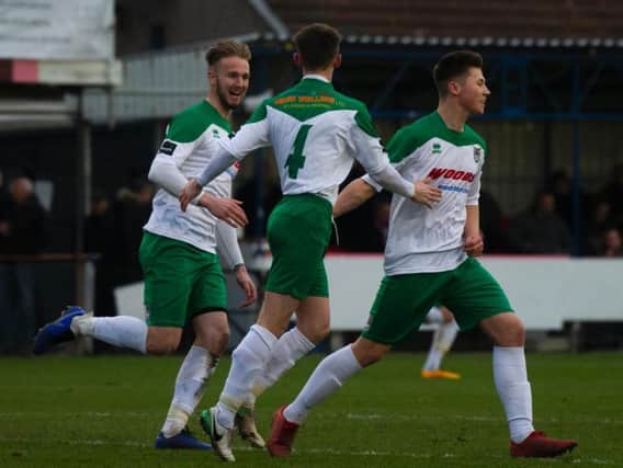 Harvey Read and Doug Tuck join Tommy Scutt, right, in celebrating his equaliser at Corinthian Casuals / Picture by Tommy McMillan