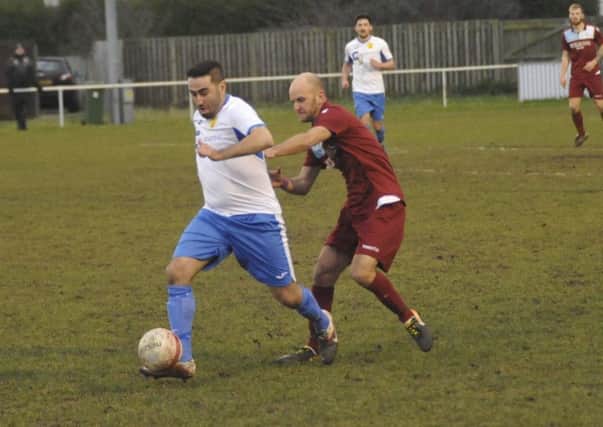 Little Common player-manager Russell Eldridge closes down a Newhaven opponent. Pictures by Simon Newstead