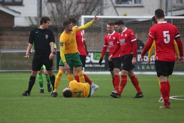 Horsham v Ramsgate. Charlie Harris is down injured after another strong tackle. Picture by John Lines