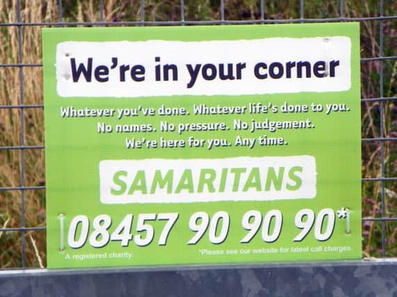 Samaritans sign on a fence  Image by Peter O\'Connor, licensed by Creative Commons from Flickr.