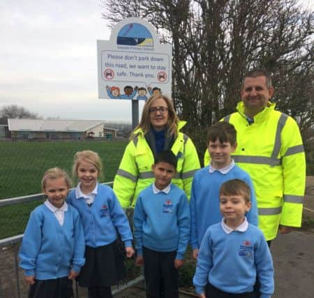 Mr Murley, Mrs Irwin and pupils at one of the entrances to Seaside Primary School