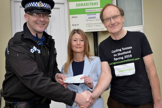 PCSO Daryl Holter is pictured handing over the cheque to Evia (branch director) and Steve (treasurer).