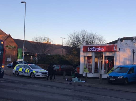 Emergency services are currently helping an injured woman who fell outside Ladbrokes in High Street, Worthing