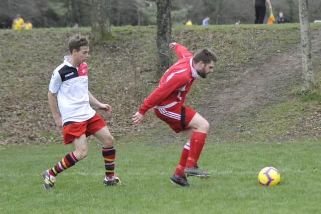 A Rock-a-Nore player shields the ball from a Peche Hill Select opponent