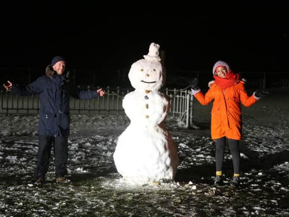 Two Worthingites showing off their snowman. Pic: Eddie Mitchell