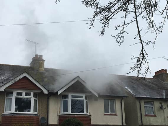 Smoke can be seen billowing from the roof of a house in Kingsham Road, Chichester.