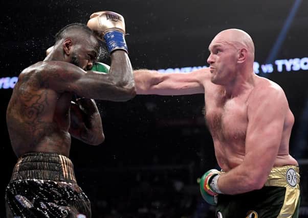 Tyson Fury punches Deontay Wilder (Photo by Harry How/Getty Images)