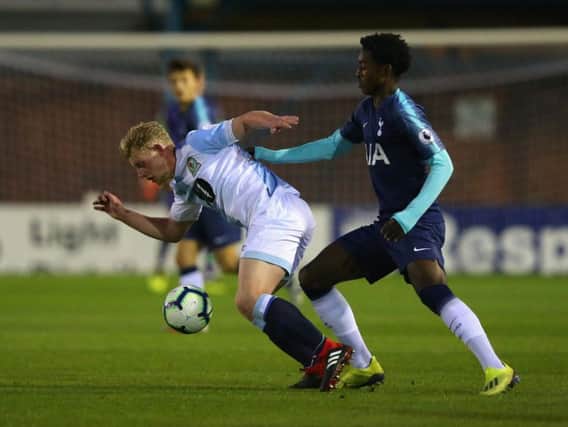 Willem Tomlinson playing for Blackburn Rovers holds off a challenge from Paris Maghoma of Tottenham Hotspur during the Premier League 2 match between in September (Photo by Alex Livesey/Getty Images)