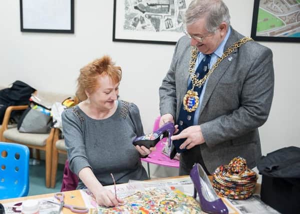 Mayor of Hastings Councillor Nigel Sinden and artist Susan Cleland learn new upcycling skills at Sheryl Hall's shoe workshop SUS-190502-094311001