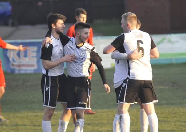 Bexhill United celebrate their third goal in the 4-0 win at home to Worthing United. Pictures by Simon Newstead