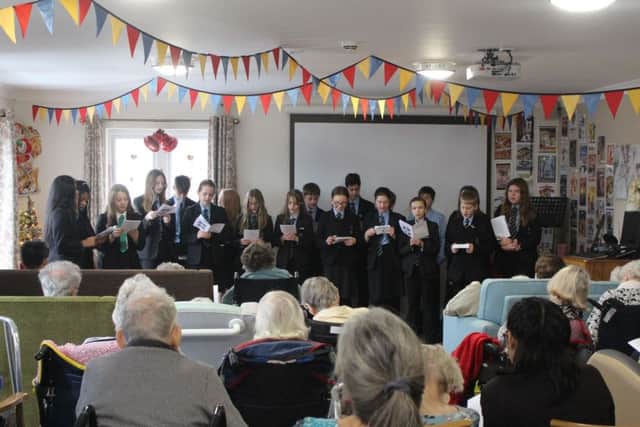 The Chatsmore High School choir performing at Haviland House, Guild Care's specialist dementia care home