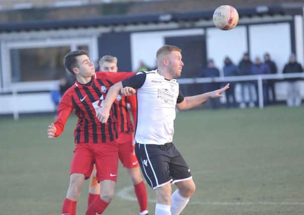Zack McEniry holds off an opponent during Bexhill United's 4-0 win at home to Worthing United. Picture by Simon Newstead