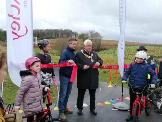 Councillor Burgess cuts the ribbon on the pump track