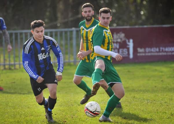 Hollington United midfielder Ricky Martin tussles for possession during the 7-0 win away to AFC Uckfield Town II. Picture by Justin Lycett