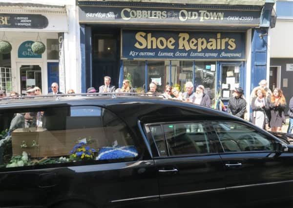The hearse carrying John's coffin outside his shop. Picture by Andrew Clifton SUS-181005-123351001