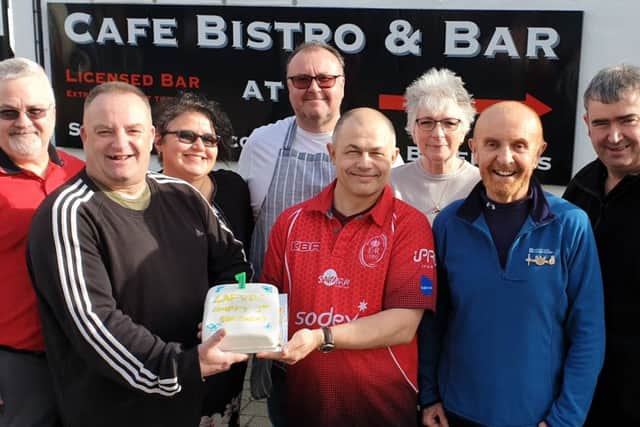 Celebrating the first birthday, vice-chairman Ian Buckland, left, and chairman Ian Neville with the cake, and Cafe 72 owner Gary Hughesdon with his wife Ruth, behind
