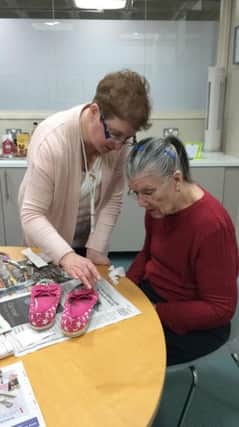 Learning thrifty shoe upcycling skills at Sheryl Hall's free Art Workshop held to raise awarness of Narcolepsy. SUS-191202-151247001