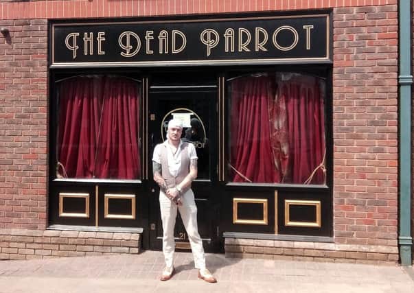 Andy outside the Dead Parrot bar SUS-180727-160136001