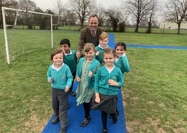 Arundel & South Downs MP Nick Herbert with pupils from St Peters CE Primary School in Henfield on the St Peters Metres running track SUS-190213-104008001