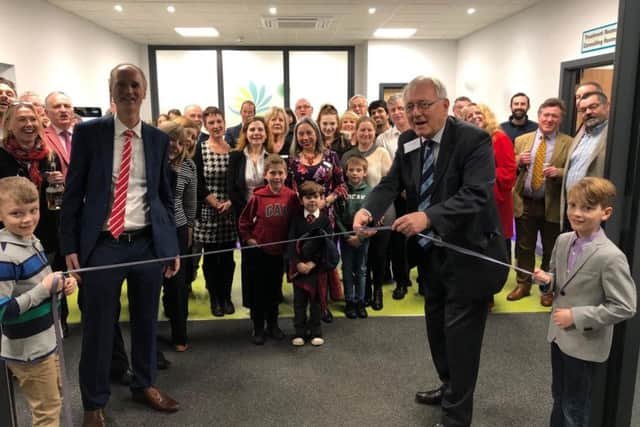Sir Peter Bottomley cutting the ribbon at the new Strand Medical Group practice