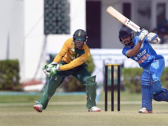 South African wicketkeeper AB de Villiers watches as India A cricketer Manan Vohra plays a shot (Photo PRAKASH SINGH/AFP/Getty Images)