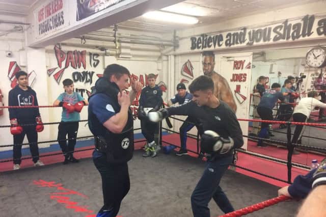 A student undergoes intense boxing drills in the ring as part of his WBC Cares training programme