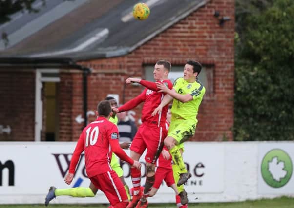 Hastings United defender Tom Climpson goes up for a header during last weekend's 1-1 draw away to Whitstable Town. Picture courtesy Scott White